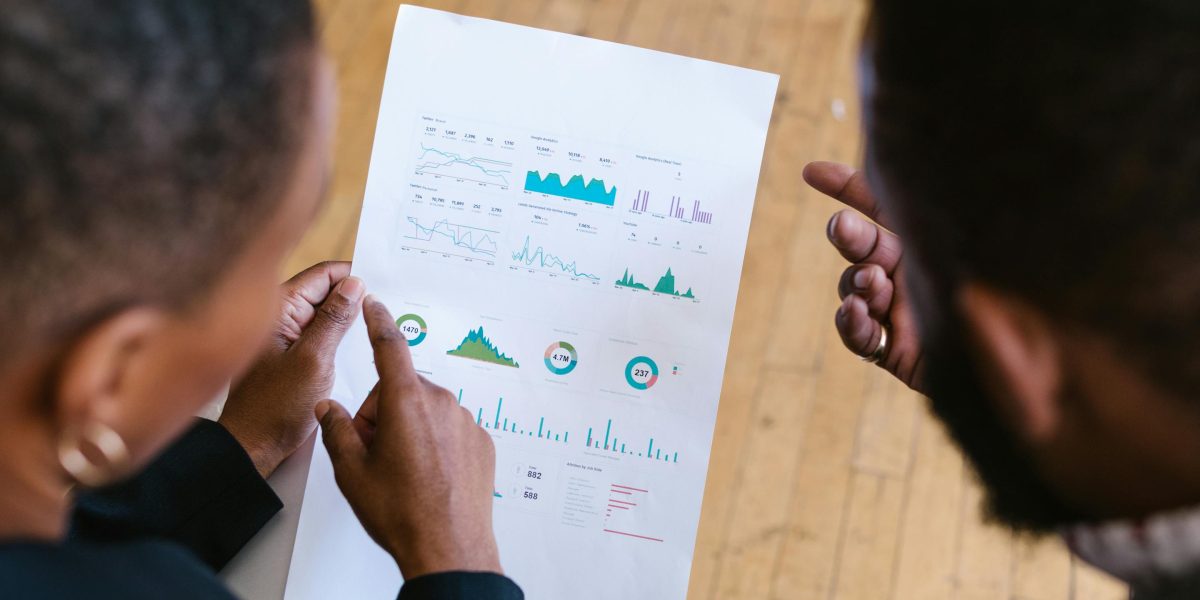 A team collaborating while reviewing performance data and analytics on a dashboard.