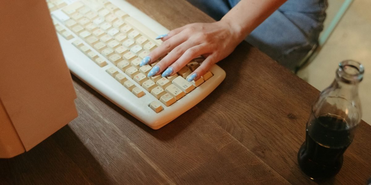 A person showing slight frustration while typing, symbolizing the common occurrence of misspellings due to speed.