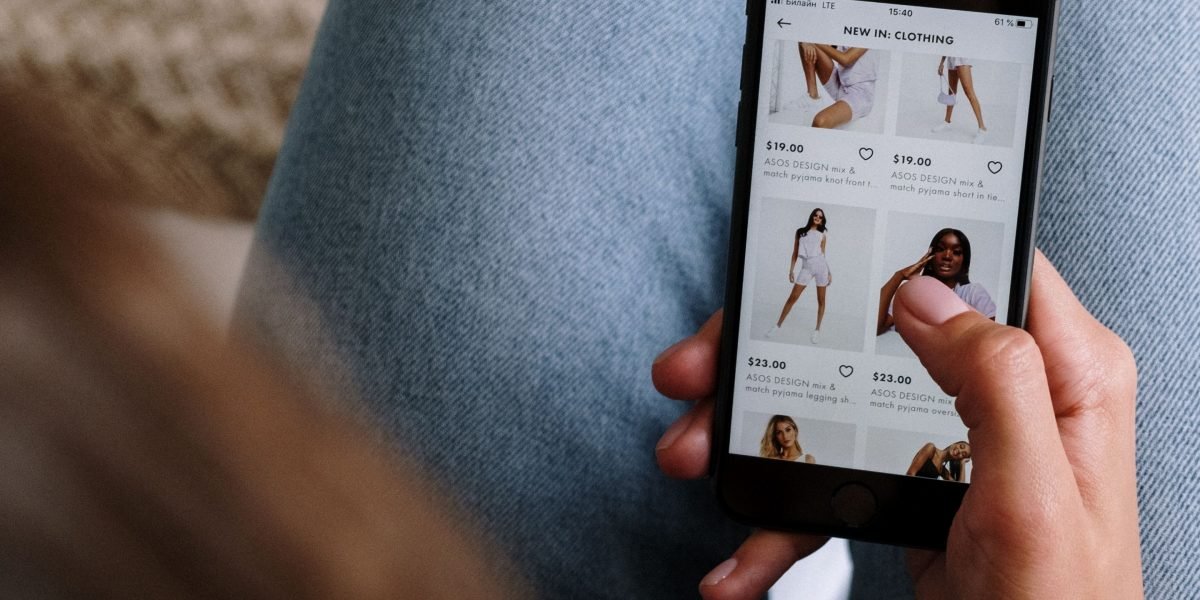 A person engaging with online fashion content, reflecting the diverse product categories available through Macy's.
