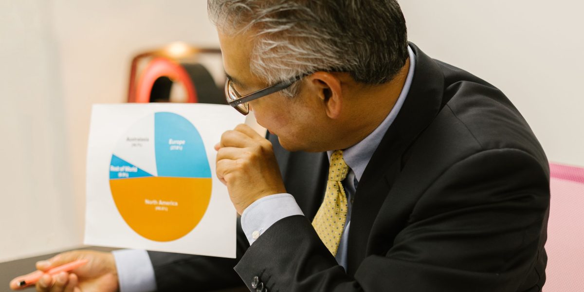A business professional meticulously reviewing data to make informed decisions about high-converting affiliate programs.