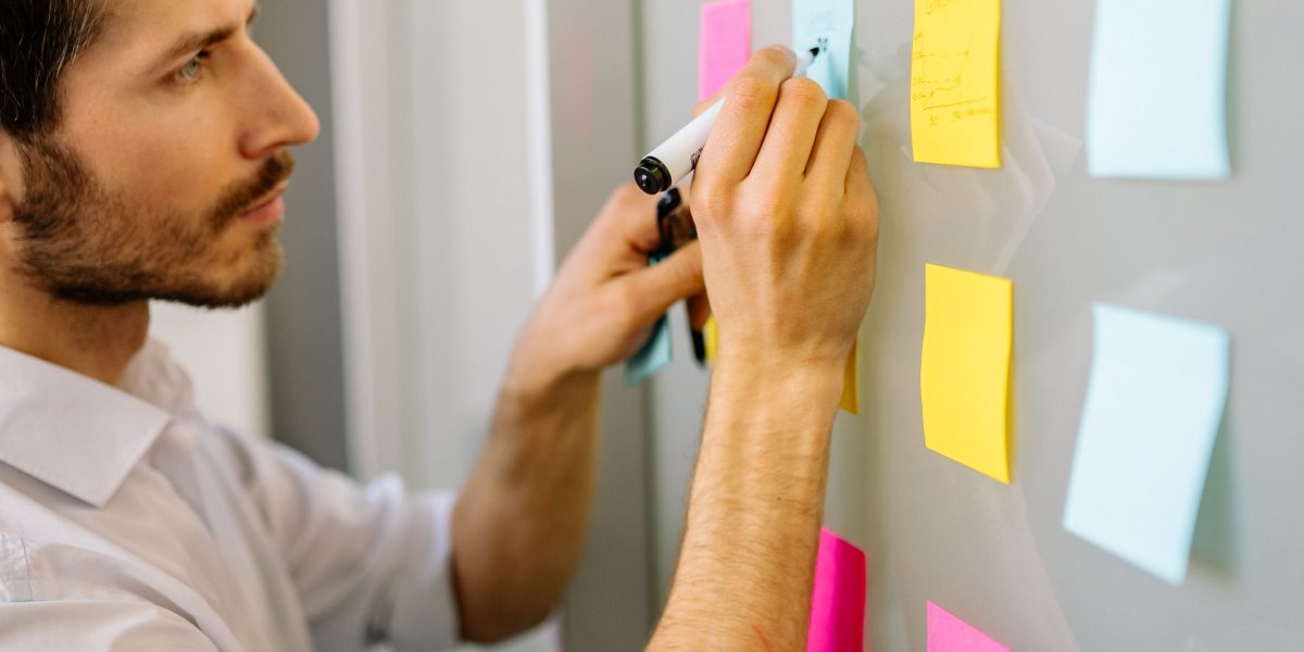 A person engaged in strategic planning, reviewing documents to make informed decisions.