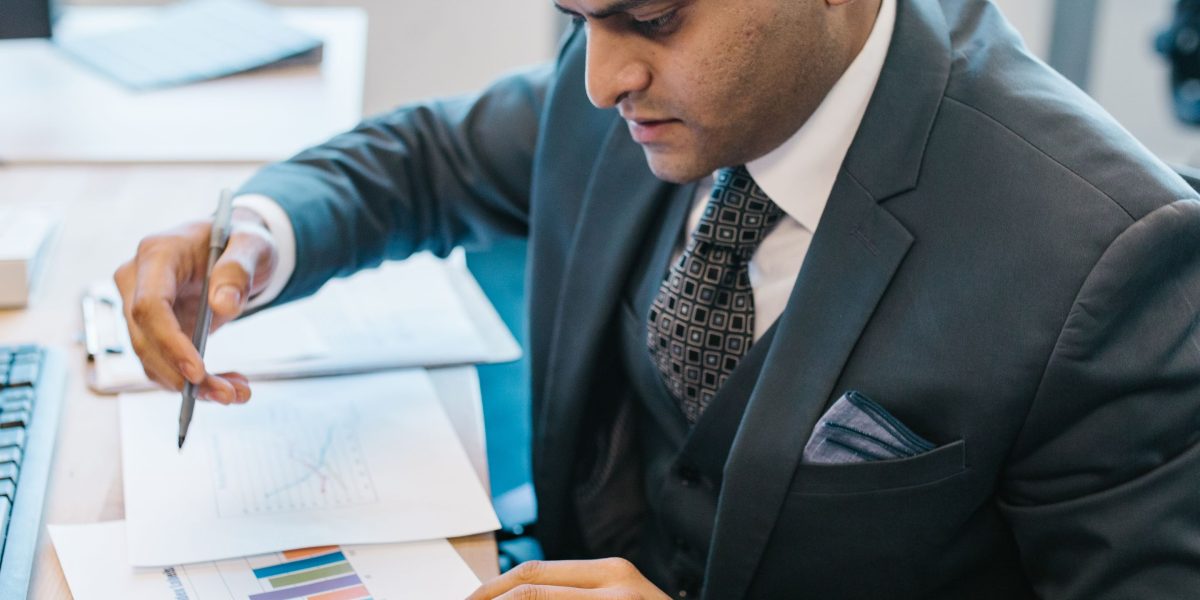 A person reviewing charts and data, focused on understanding business performance and growth.