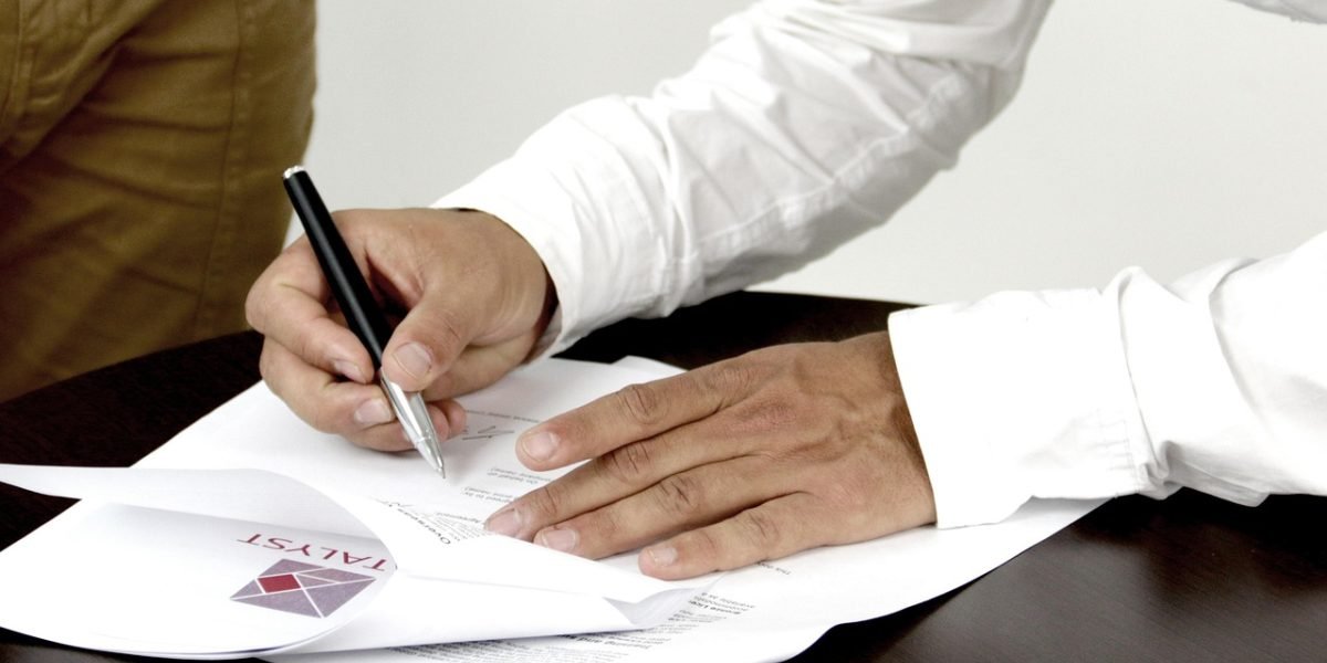 An individual thoughtfully reviewing documents, embodying the careful evaluation process for affiliate programs.