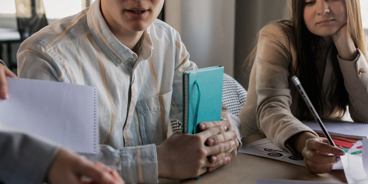 Individuals exchanging ideas about financial tools and investment strategies, like micro-investing apps.