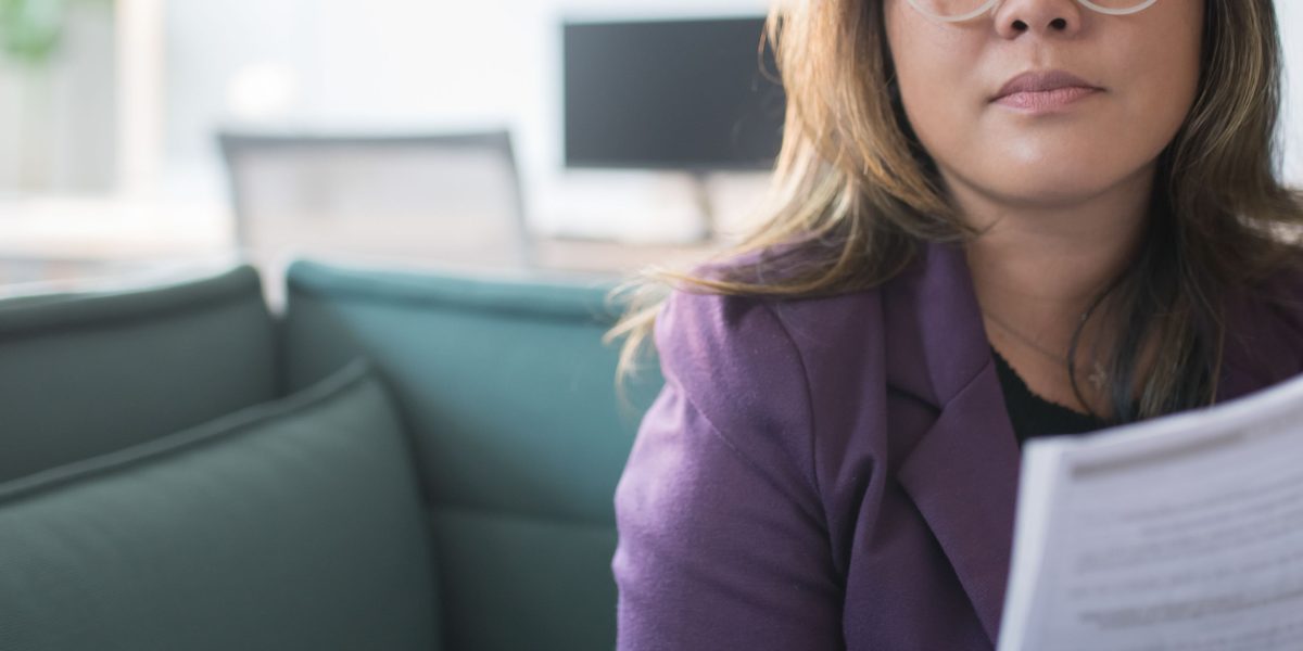 A person confidently reviewing business plans, reflecting strategic choices for success.
