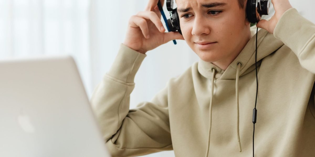 An individual deeply engaged in an online course, highlighting the appeal of high-ticket education offers.