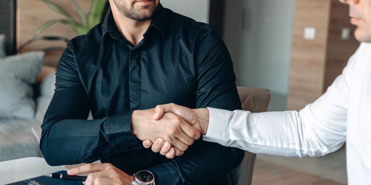 Two business professionals shaking hands, symbolizing a successful and collaborative partnership.