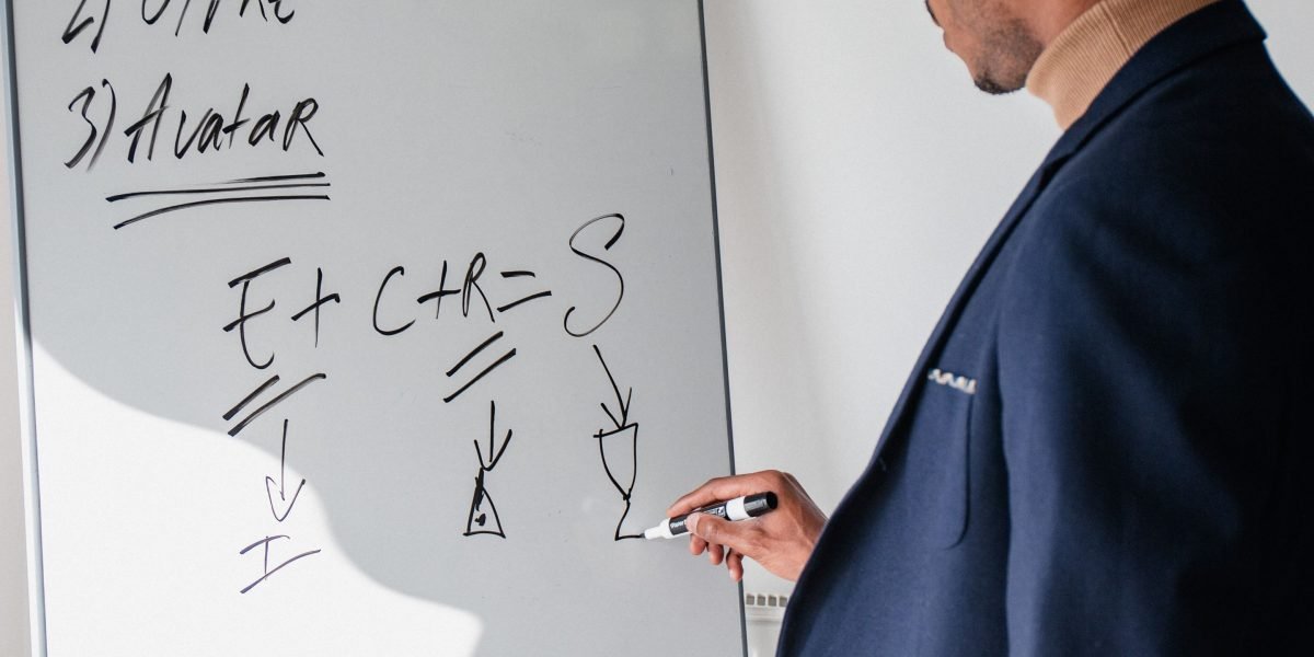 An individual uses a whiteboard to outline a career or business strategy, symbolizing thoughtful planning for affiliate success.