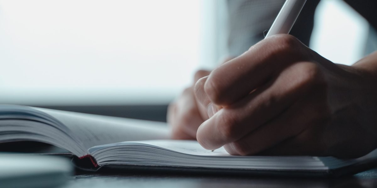 An individual planning their affiliate marketing strategy to identify high-converting software programs.