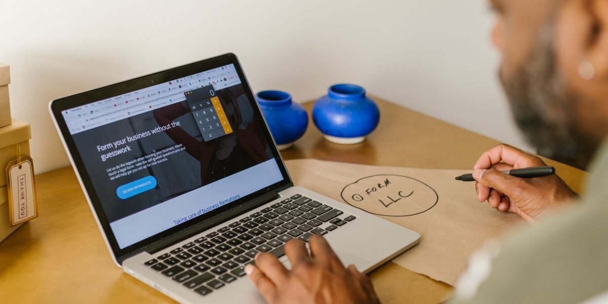 An individual thoughtfully planning their strategy to build an online business and achieve financial goals.