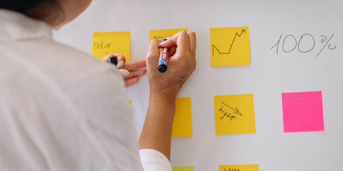 A person outlining a plan or checklist on a whiteboard, illustrating the decision framework and migration steps.