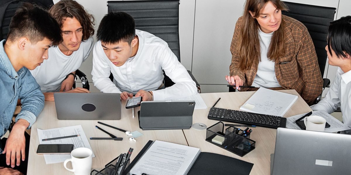 A team collaborating effectively, integrating AI tools into their workflow to scale operations and enhance efficiency.